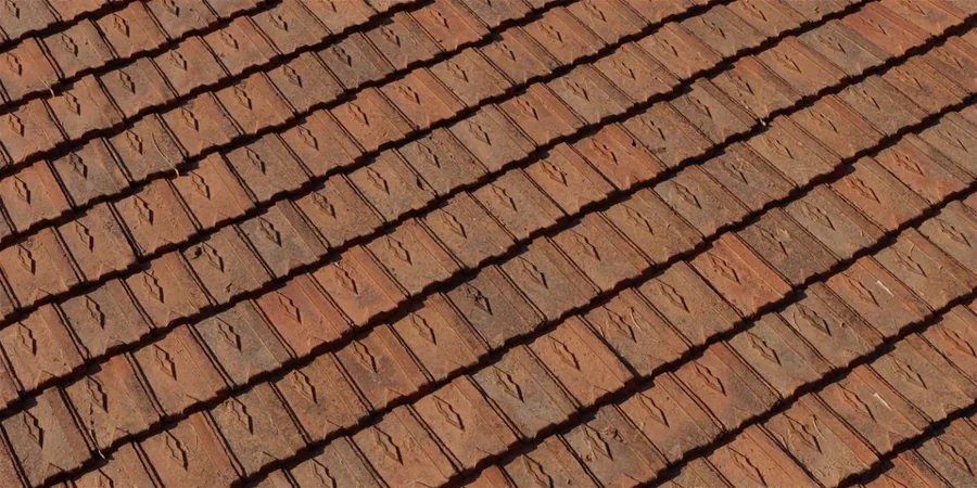 Rows of brown concrete roof tiles